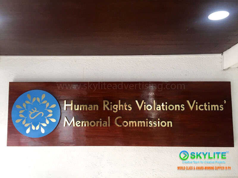 human rights commission brass sign on wood finish 2 1