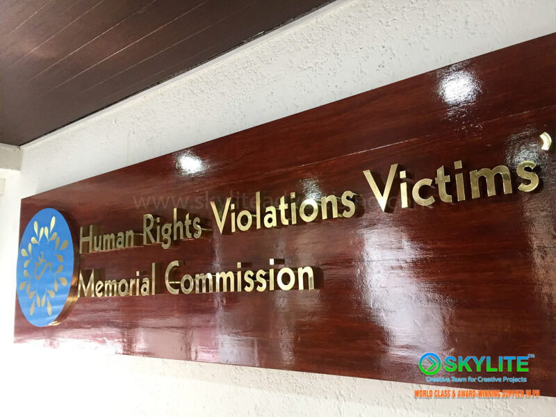human rights commission brass sign on wood finish 3 1