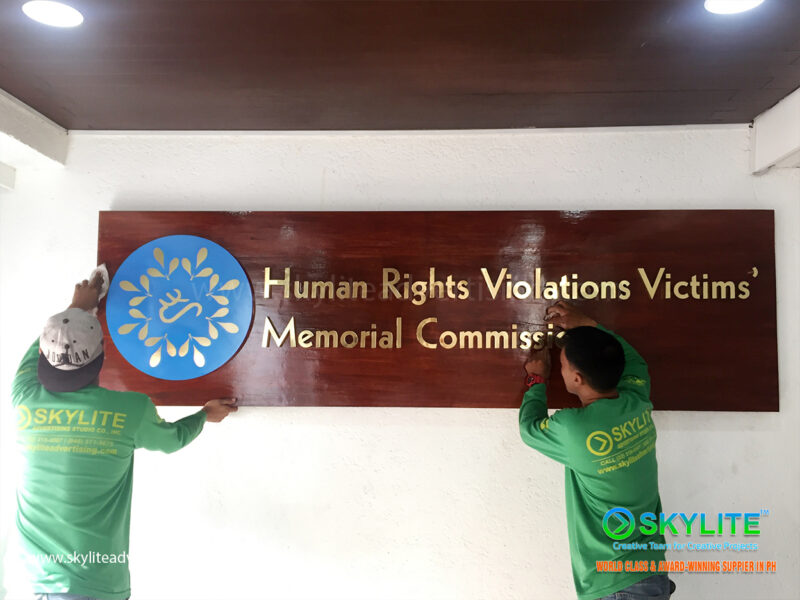 human rights commission brass sign on wood finish 4 1