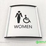 designed by benc mens womens restroom sign curved metal with metal inserts